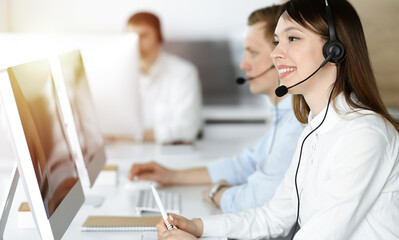 Asian woman working at customer service office. Business concept. Group of diverse operators at...