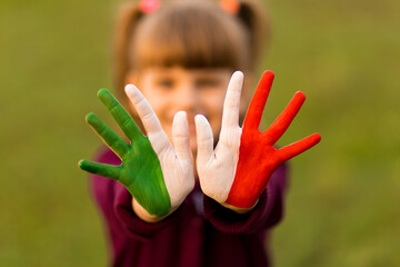 Painted kid hands in italy flag colors.
