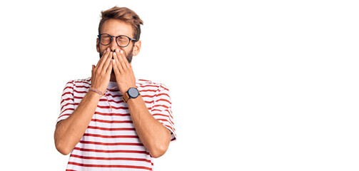 Handsome blond man with beard wearing casual clothes and glasses laughing and embarrassed giggle...