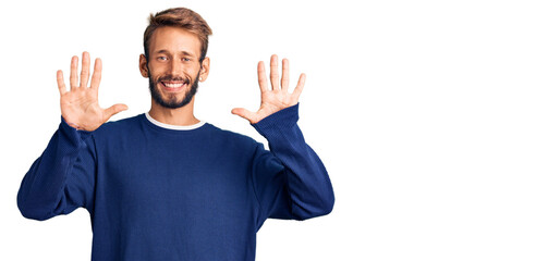 Handsome blond man with beard wearing casual sweater showing and pointing up with fingers number ten while smiling confident and happy.