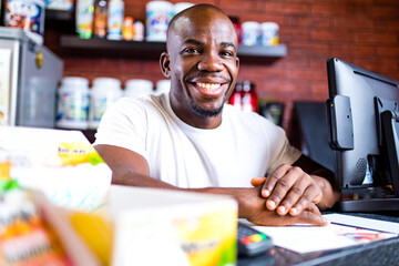 hispanic man selling professional plastic jar with sport nutrition in reception of gym