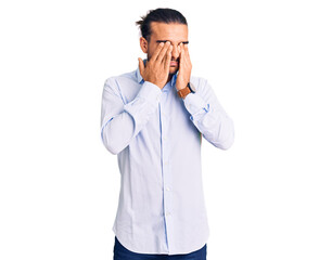 Young handsome man wearing business clothes rubbing eyes for fatigue and headache, sleepy and tired expression. vision problem