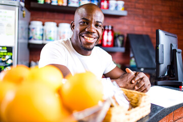 hispanic man selling professional plastic jar with sport nutrition in reception of gym