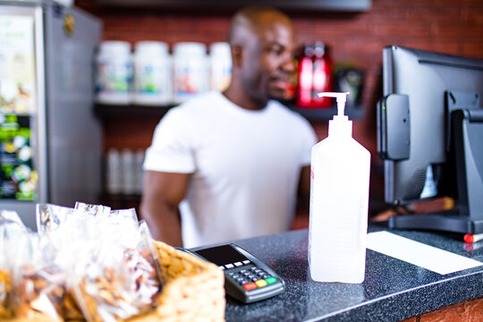 afro american man receptionist sanitizing work surface desk