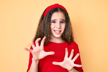 Cute hispanic child girl wearing casual clothes and diadem disgusted expression, displeased and...