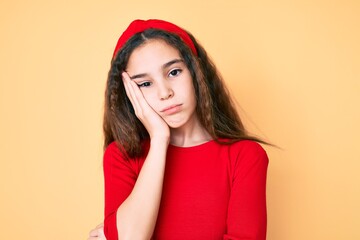 Cute hispanic child girl wearing casual clothes and diadem thinking looking tired and bored with depression problems with crossed arms.