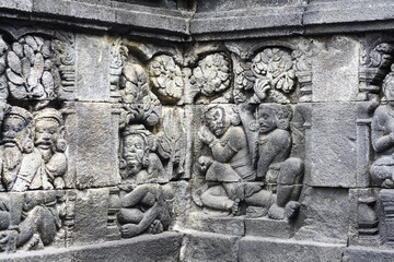 A stone wall relief at Candi Borobudur the largest Buddhist temple in the world.