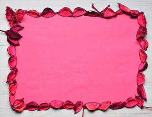 Background with dry leaves in the outline, space on a sheet of paper for text or ideas, in pink colors