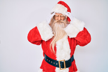 Old senior man with grey hair and long beard wearing santa claus costume suffering from headache desperate and stressed because pain and migraine. hands on head.