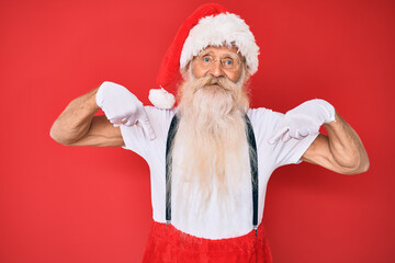 Old senior man with grey hair and long beard wearing white t-shirt and santa claus costume looking confident with smile on face, pointing oneself with fingers proud and happy.