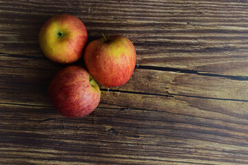 Overhead view, red and yellow apples with drops of water, on rustic wood