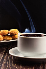 Hot liquid chocolate, in white cup and plate on the table