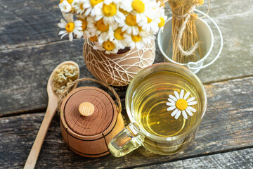 cup of herbal chamomile tea and daisy flowers. doctor treatment and prevention of immune concept, medicine - folk, alternative, complementary, traditional medicine