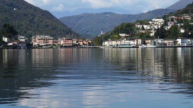 Ponte Tresa border town on Lake Lugano between Switzerland and Italy, mountains in the clouds in the background