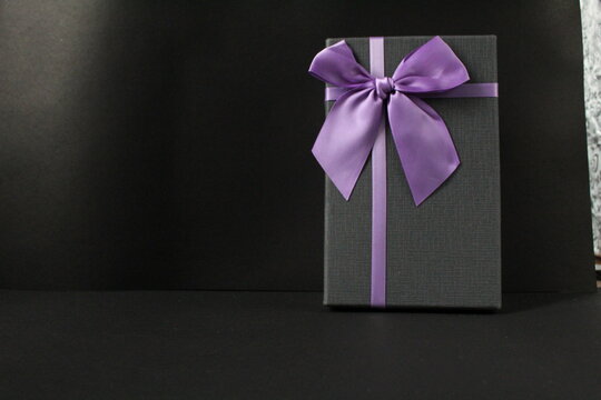 Only Black Black Gift Gift Box With Purple Lilac Fuchsia Ribbon And Bow On A Black Background With Space For Text Copy Space Father's Day New Year Christmas Birthday For Men