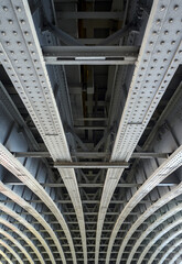 Beneath Blackfriars Railway Bridge in London, UK.  The strong steel beams with rivets underneath...