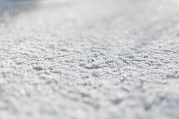 Snow surface close up macro, winter background, shallow depth of field