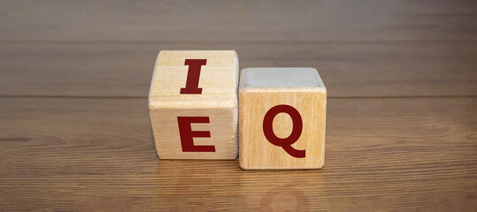 Wooden cubes with the expression 'IQ' 'Intelligence Quotient' to 'EQ' 'Emotional Intelligence...