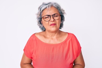 Senior hispanic grey- haired woman wearing casual clothes and glasses with hand on stomach because nausea, painful disease feeling unwell. ache concept.