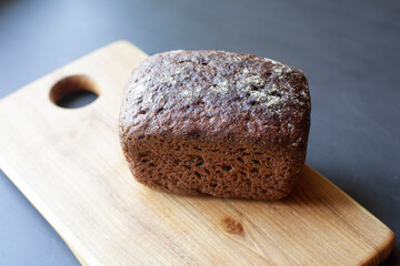 Homemade rye-wheat sourdough on a wooden board. Copy space.