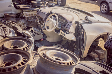 Disassembled car surrounded by various spare parts on a sob for the sale of spare parts