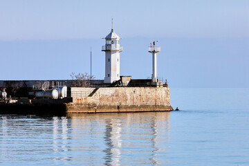 Fototapeta na wymiar lighthouse at the entrance to the bay