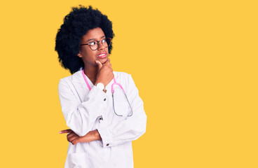 Young african american woman wearing doctor coat and stethoscope thinking worried about a question, concerned and nervous with hand on chin