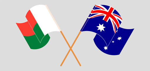 Crossed and waving flags of Madagascar and Australia