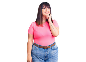 Young plus size woman wearing casual clothes looking confident at the camera with smile with...