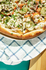 pizza on a checkered napkin in a cafe on the table natural sunlight