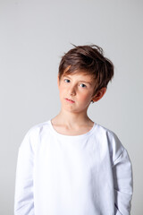 boy in white sports long sleeve t-shirt