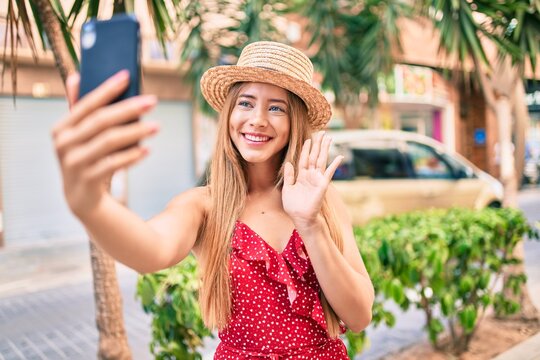 Young caucasian tourist girl smiling happy doing video call using smartphone at the city.