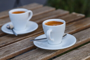 Cup of coffee on table in coffee shop cafe.A cup of coffee and coffee beans with croissant on the table