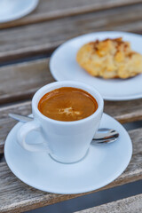 Cup of coffee on table in coffee shop cafe.A cup of coffee and coffee beans with croissant on the table
