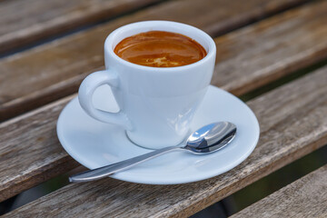 Cup of coffee on table in coffee shop cafe.A cup of coffee and coffee beans with croissant on the table