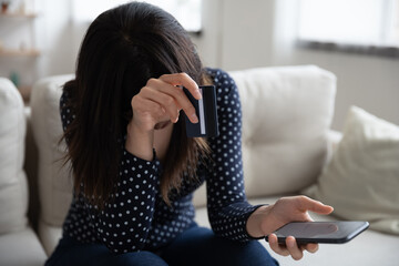 Upset woman feel stressed having problems paying on cellphone with bank credit card. Unhappy...