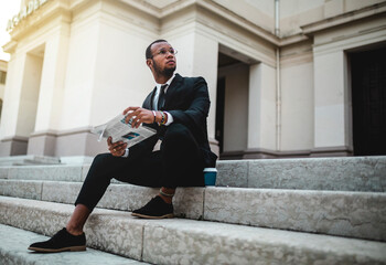 Sitting businessman reads the paper.