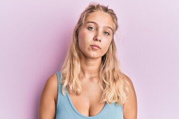 Young blonde girl wearing casual clothes relaxed with serious expression on face. simple and natural looking at the camera.