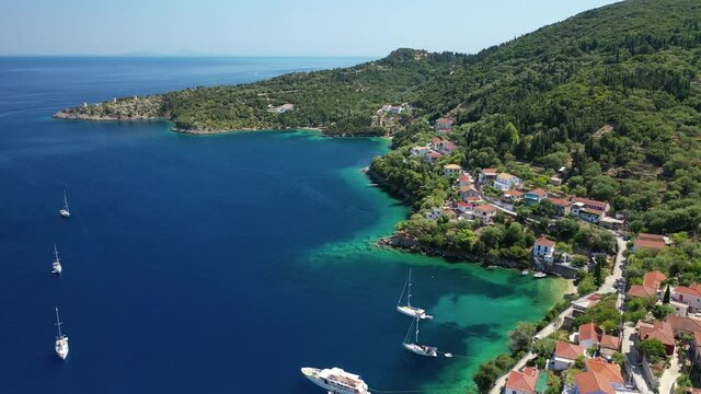 Aerial drone video of picturesque beautiful seaside village of Kioni a safe anchorage for yachts and sail boats, a true gem of Ithaki or Ithaca island, Ionian, Greece