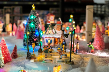 Naklejka na ściany i meble Santa Clause house, xmas holidays, Christmas time, street in snow, miniature of winter scene with houses, people, trees, Christmas concept.