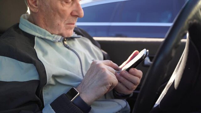 elderly caucasian man sitting in car and using phone. active modern pension people