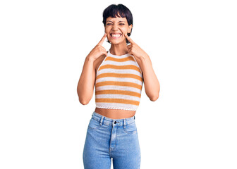 Fototapeta premium Young brunette woman with short hair wearing casual clothes smiling with open mouth, fingers pointing and forcing cheerful smile