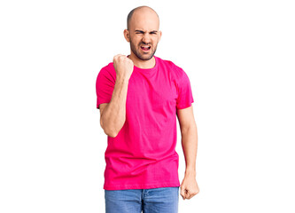 Fototapeta premium Young handsome man wearing casual t shirt angry and mad raising fist frustrated and furious while shouting with anger. rage and aggressive concept.