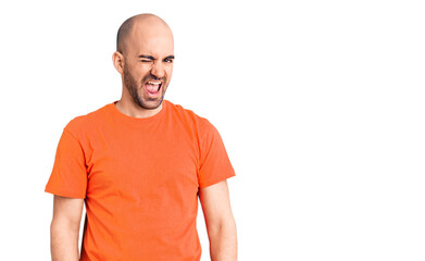 Fototapeta premium Young handsome man wering casual t shirt winking looking at the camera with sexy expression, cheerful and happy face.