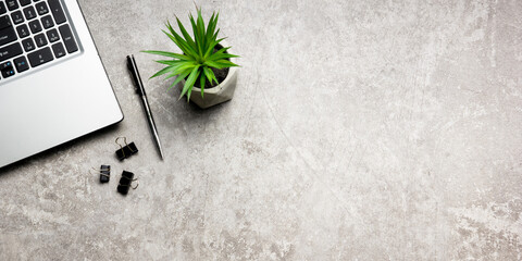 White desk office with laptop, smartphone and other work supplies with cup of coffee. Top view with...