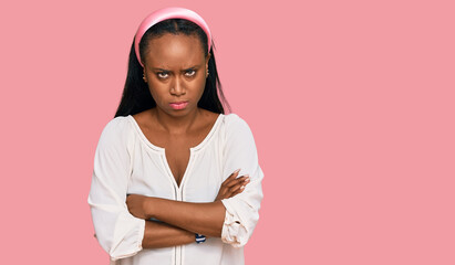 Obraz premium Young black woman wearing casual clothes skeptic and nervous, disapproving expression on face with crossed arms. negative person.