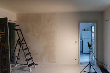 House renovation with wall being prepared to be painted