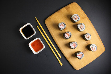 A set of sushi rolls is served on a dark background. Japanese menu. Delicious traditional japanese...