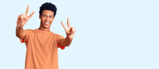 Young african american man wearing casual clothes smiling with tongue out showing fingers of both...