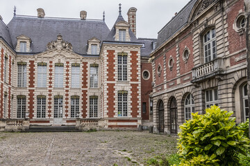 Beautiful architecture of ancient French buildings: Brick and stone building known today as Hotel...